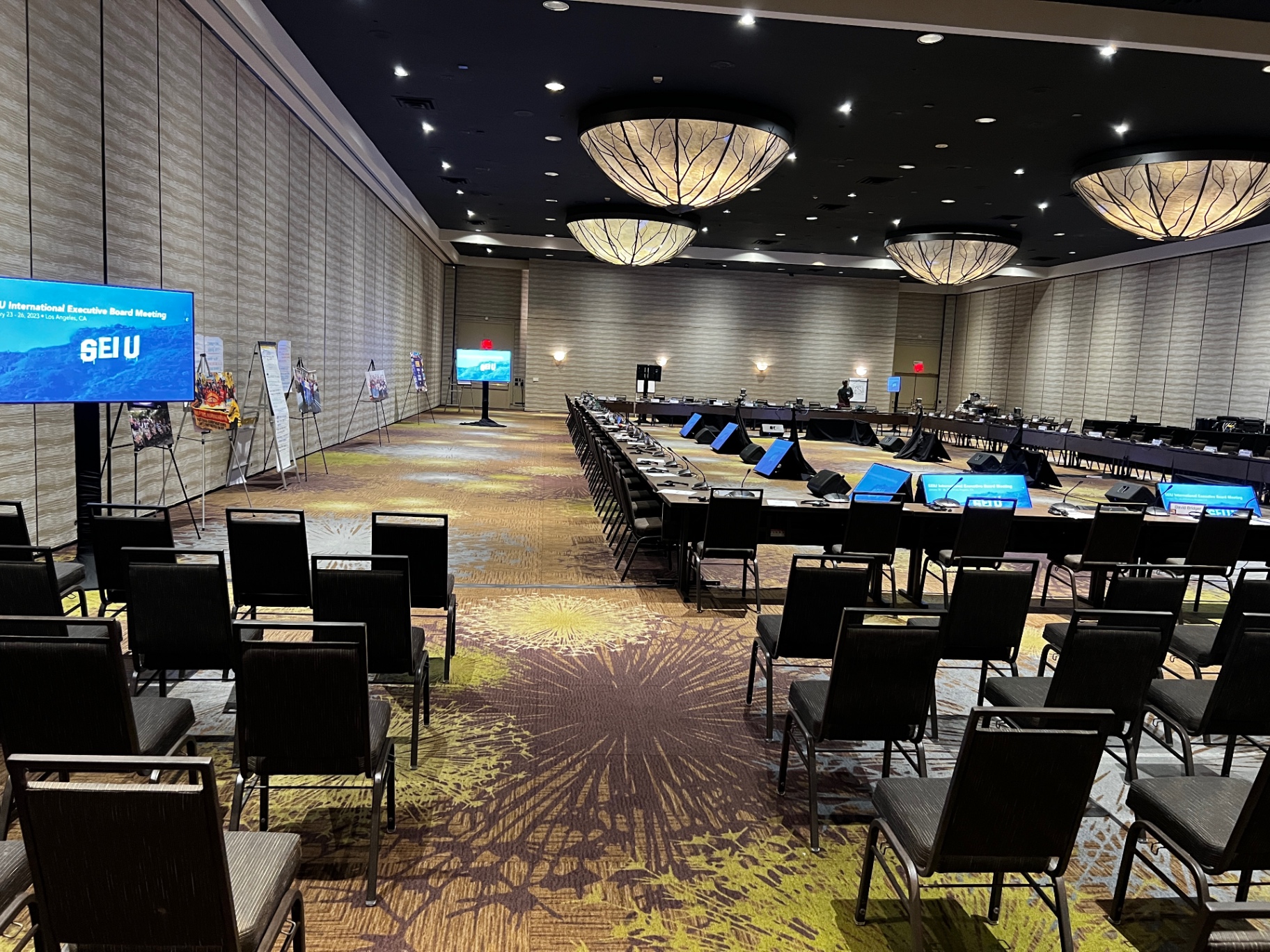 SEIU International Executive Board Meeting ballroom setup with U-shaped delegate tables, mic stations and dual LED displays
